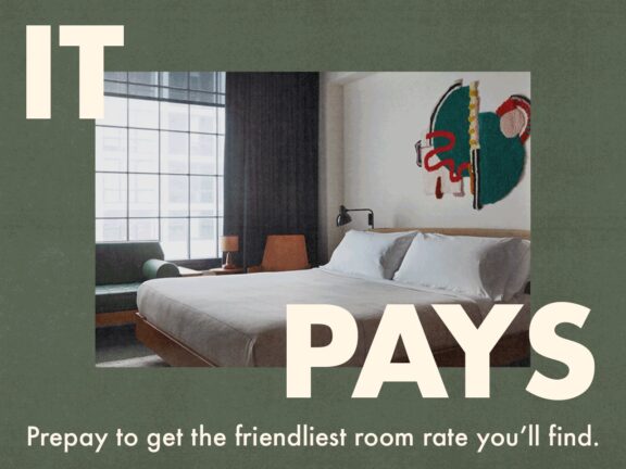 Minimalist hotel room with a large bed, modern decor, and text promoting prepaid room rates for better prices.
