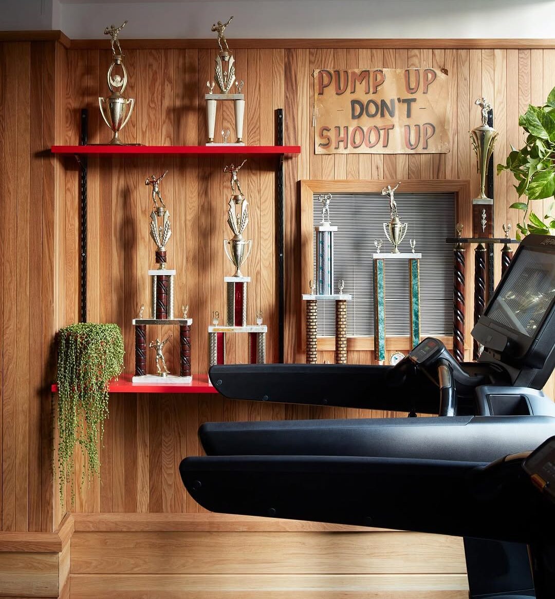 a photo of a gym with equipment that includes treadmills. A sign that reads, 