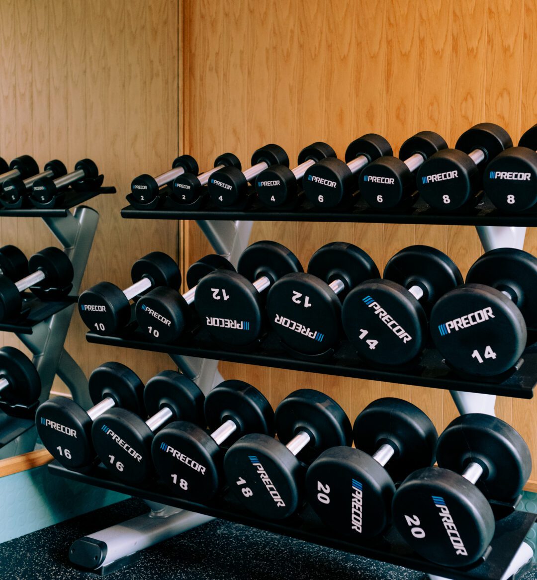 a photo of a gym with equipment that includes free weights.