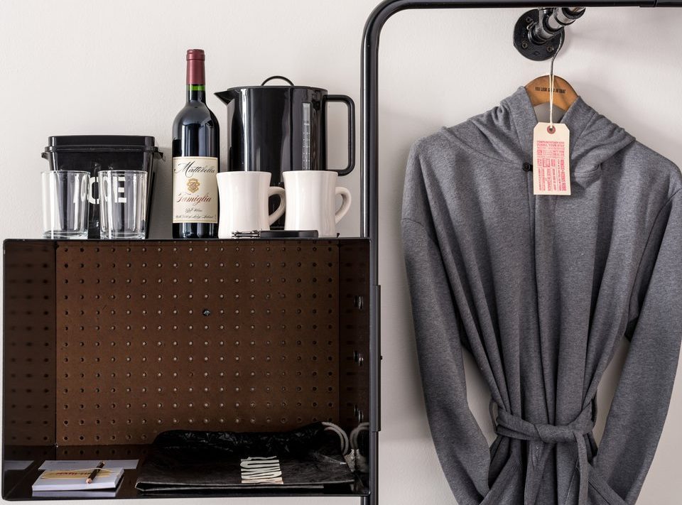 A desk provides space to work and has an ice bucket, kettle and wine for consumption