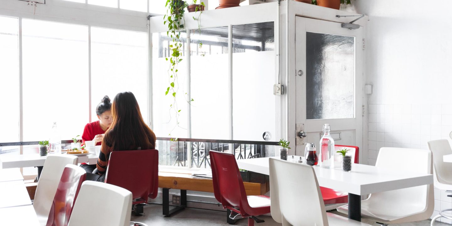 Two women eating a meal in a restaurant
