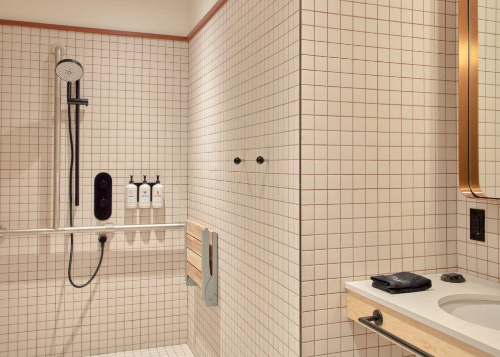 An accessible shower features plenty of room and a movable shower head